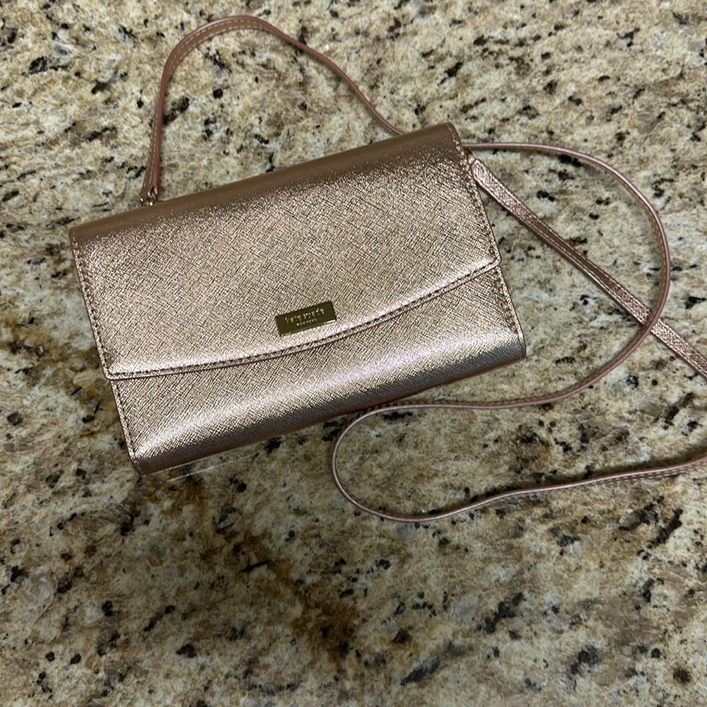 Kate Spade cross body rose gold purse snaps closed with cc spaces and zip pocket